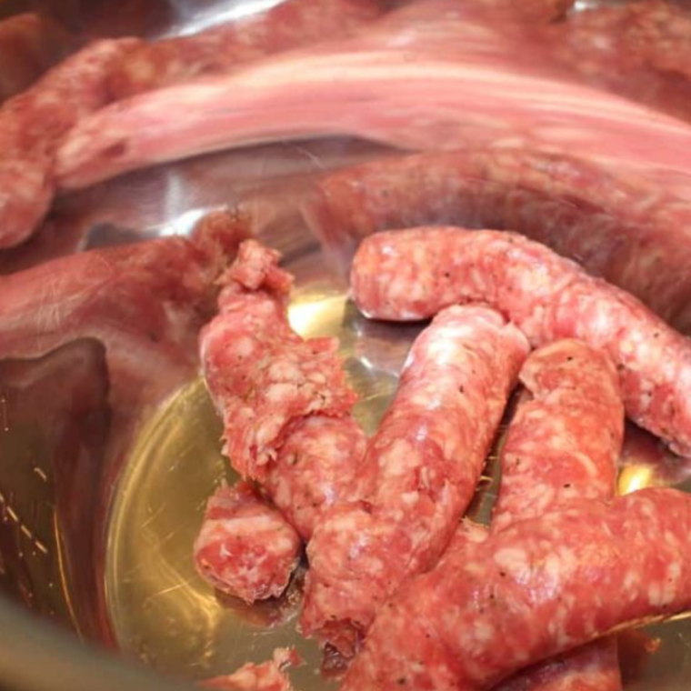 Sautéing Sausage - A close-up of sausage browning in the Instant Pot, highlighting the sizzle and flavor development.