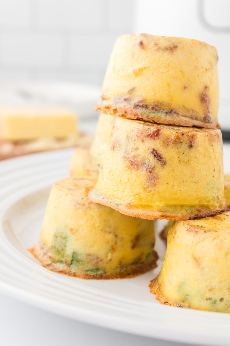 "A bowl of finished Instant Pot Keto Egg Bites, ready to eat, with a sprinkle of chives on top."