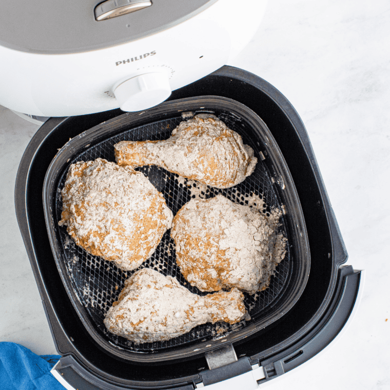 Golden air fryer Kentucky Kernel fried chicken cooked crisp in the air fryer basket