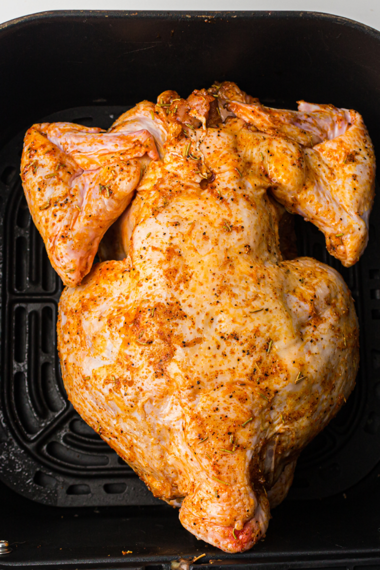 Place chicken breast side down in air fryer basket cooking