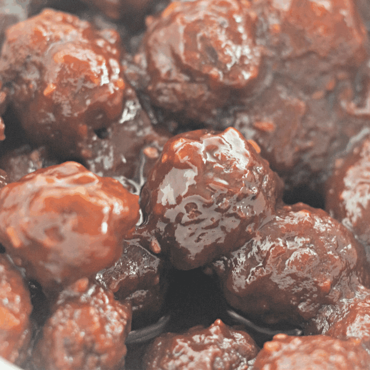 Delicious Instant Pot Honey Garlic BBQ Meatballs served on a platter or in a bowl, garnished with sesame seeds and fresh green onions.