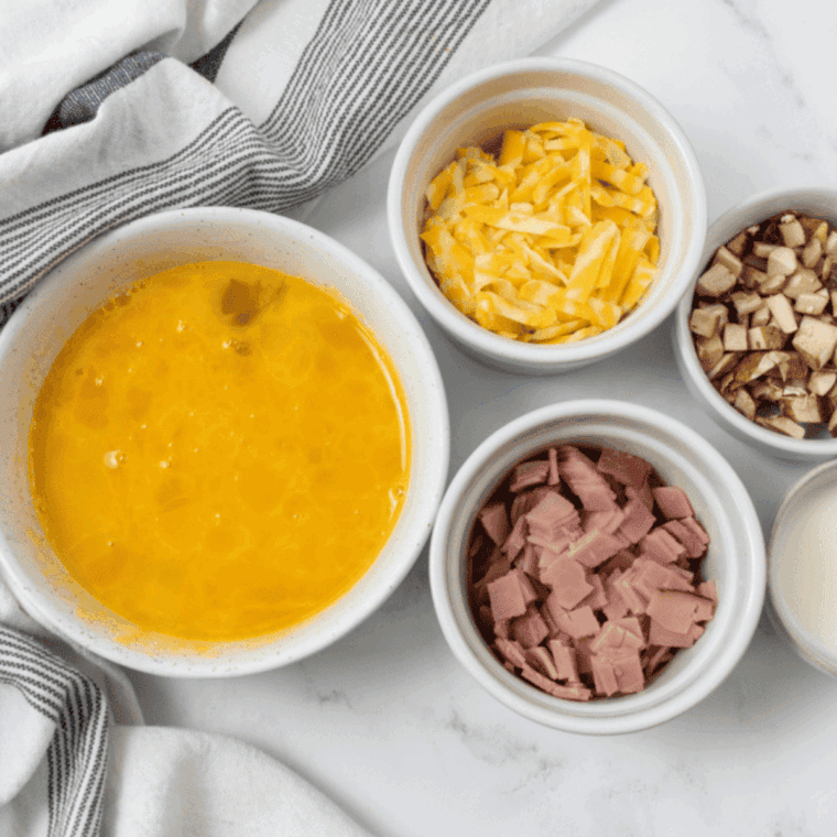 Ingredients needed for Air Fryer Cheese Omelette on kitchen table.