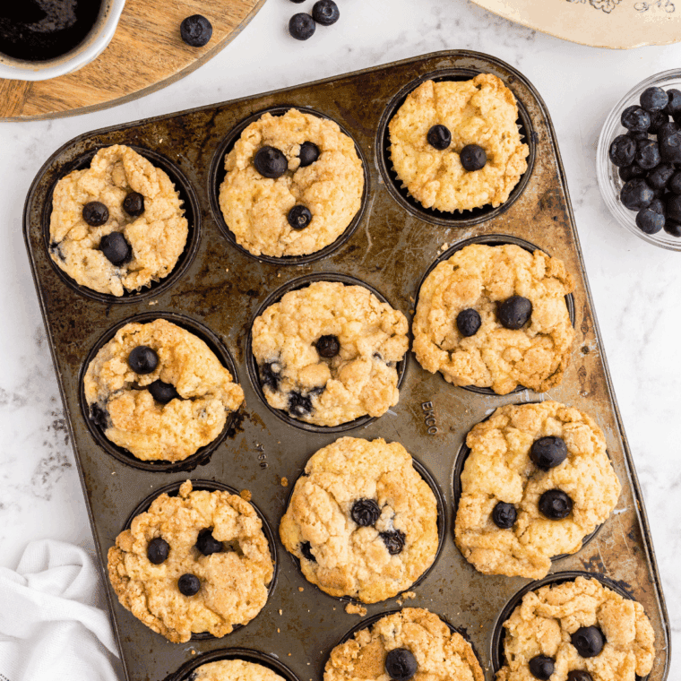 Golden air fryer blueberry lemon muffins with juicy blueberries and bright lemon zest, freshly baked and ready to enjoy.