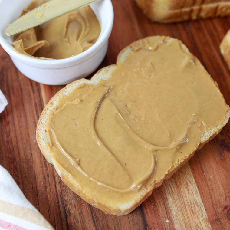 Loaded peanut butter banana toast returning to air fryer for final warm-up