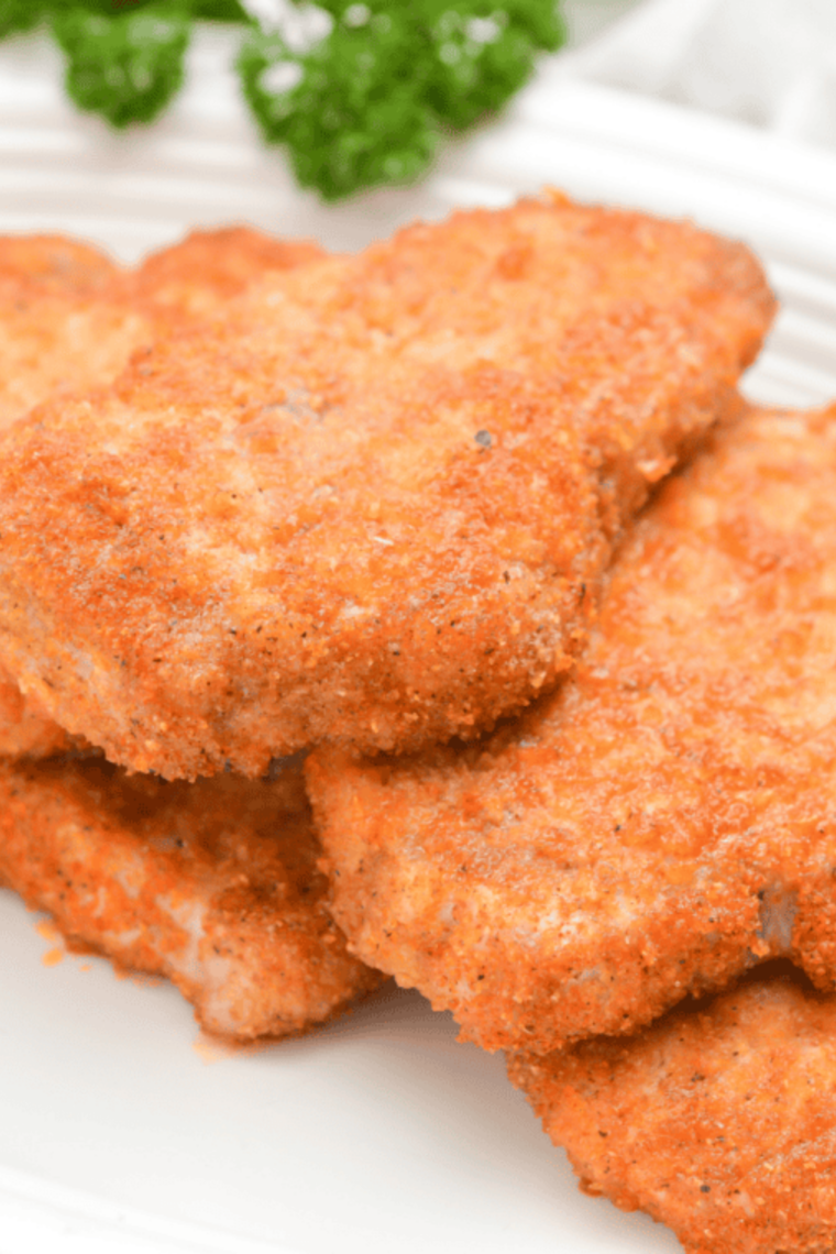 Close-up of baked Shake & Bake chicken coated in BBQ seasoning with a glossy sauce and crunchy texture visible.
