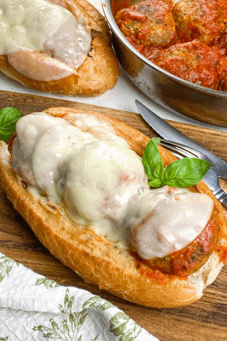 Homemade copycat Firehouse meatball sub with marinara sauce and melted provolone on a toasted hoagie roll.