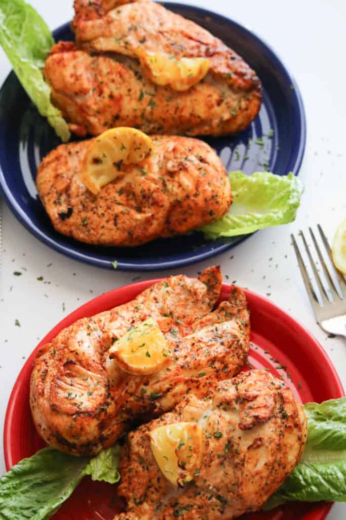 red and blue plates with lemon pepper chicken