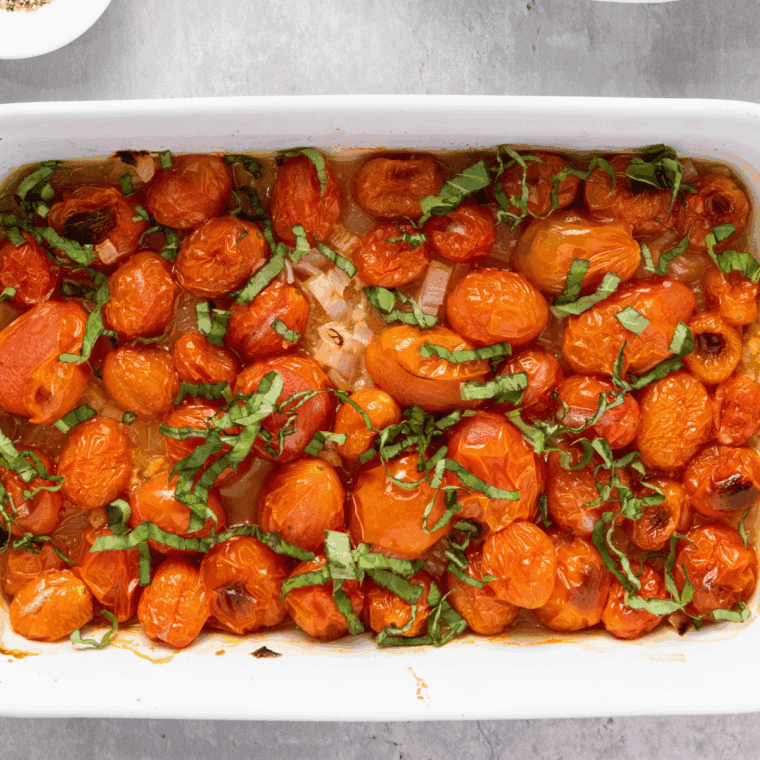 Roasted cherry tomatoes bursting open with golden edges.