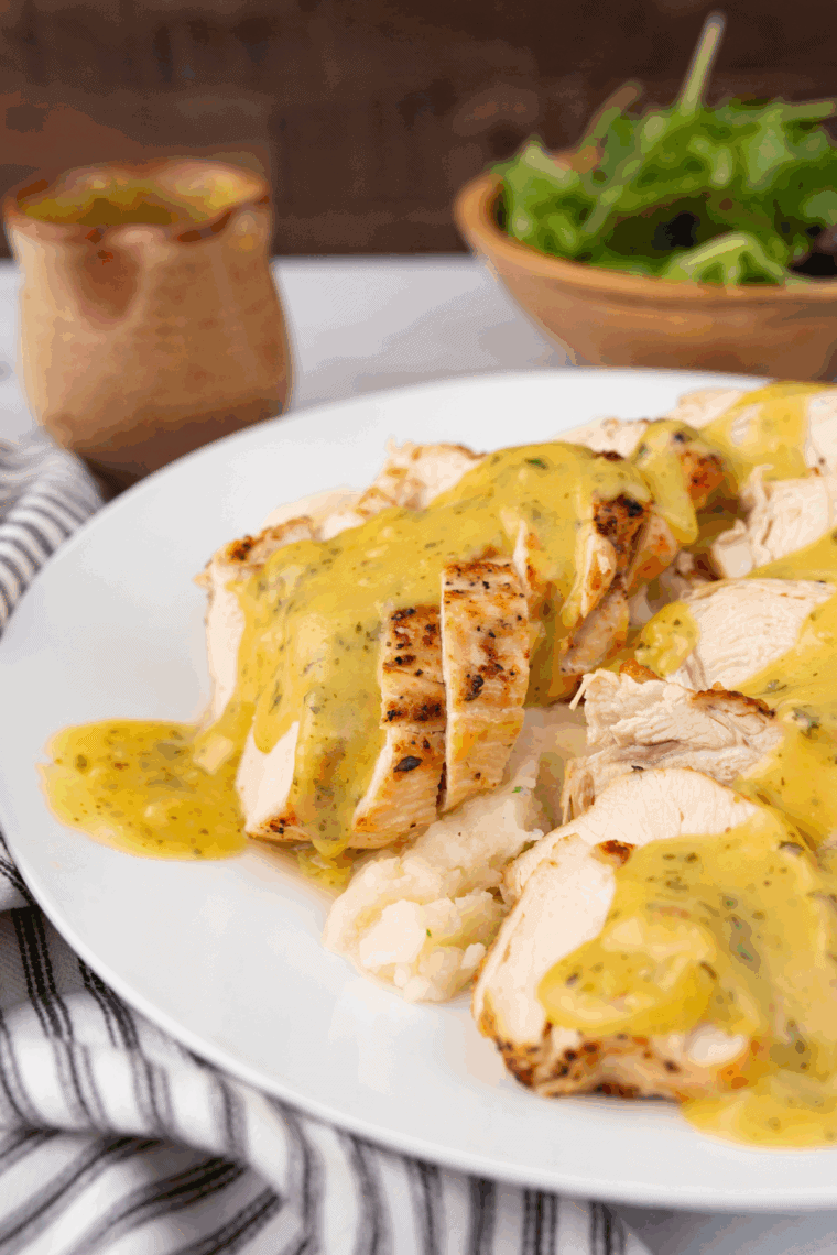 Plate of Easy Copycat Cheddar’s Dijon Chicken and Mushrooms topped with creamy Dijon sauce and sautéed mushrooms.