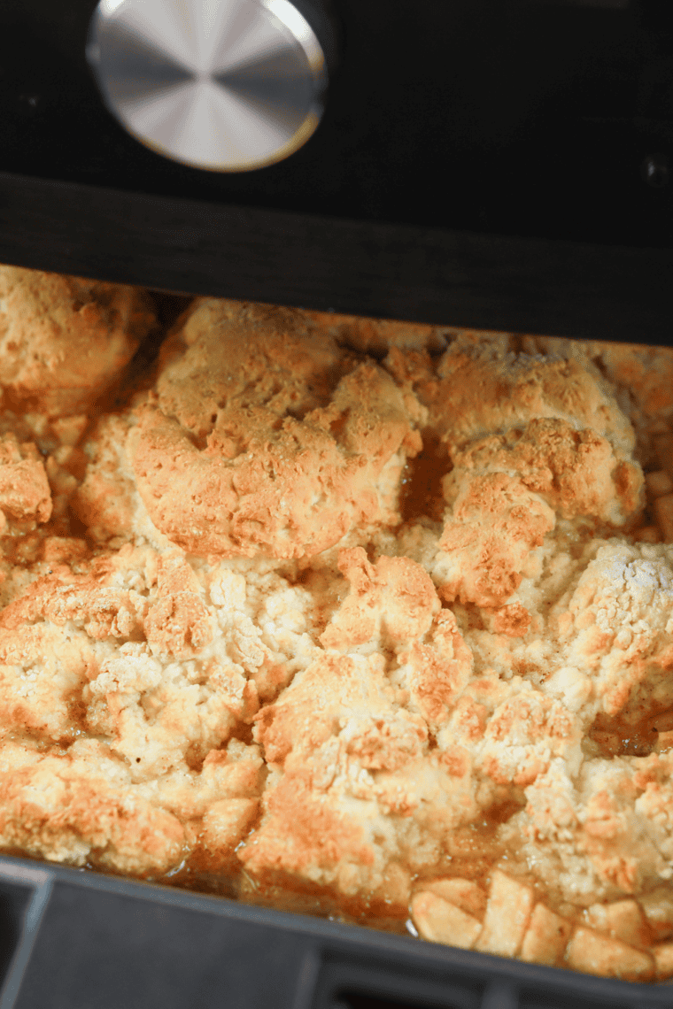Golden air fryer apple cobbler with tender apples and crispy topping in a baking dish.