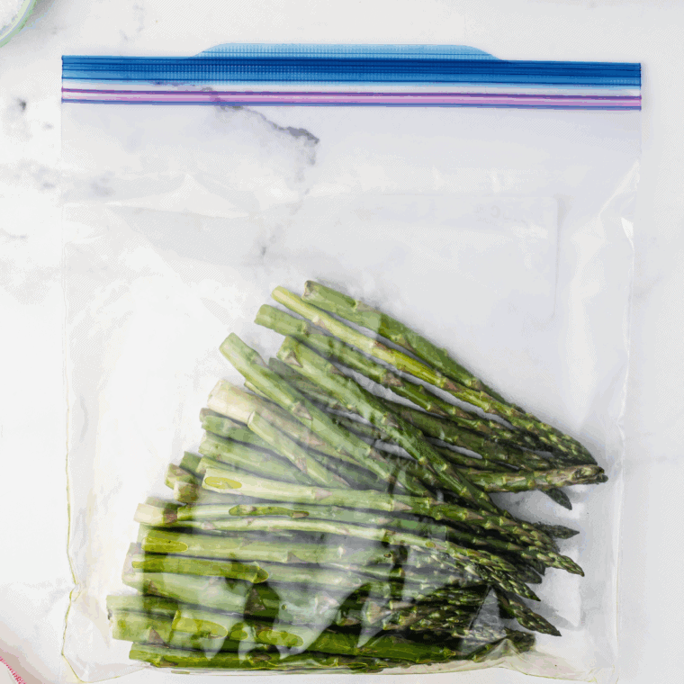Place olive oil and seasonings on the asparagus.