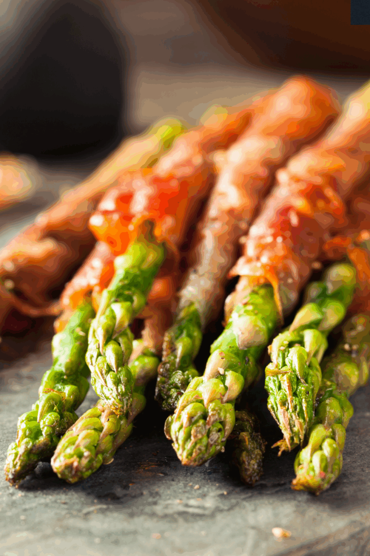 Platter of Air Fryer Prosciutto Wrapped Asparagus with crispy ham and tender green spears.