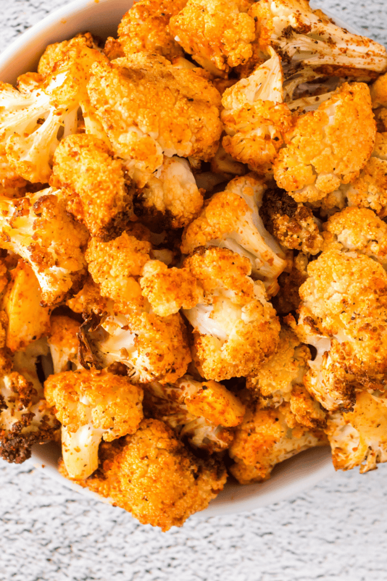 Golden, crispy air fryer cauliflower served on a plate, seasoned and ready to enjoy.