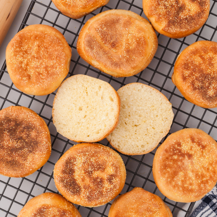 Fork split English muffin halves, exposing the nooks and crannies, ready to be air fried cut side up.