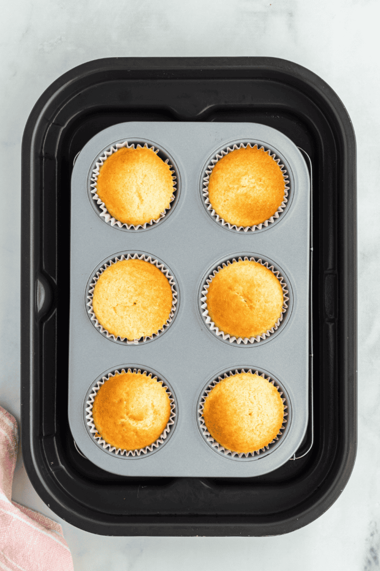 Cool and Frost – Cooling cupcakes on a wire rack before adding frosting or decorations.