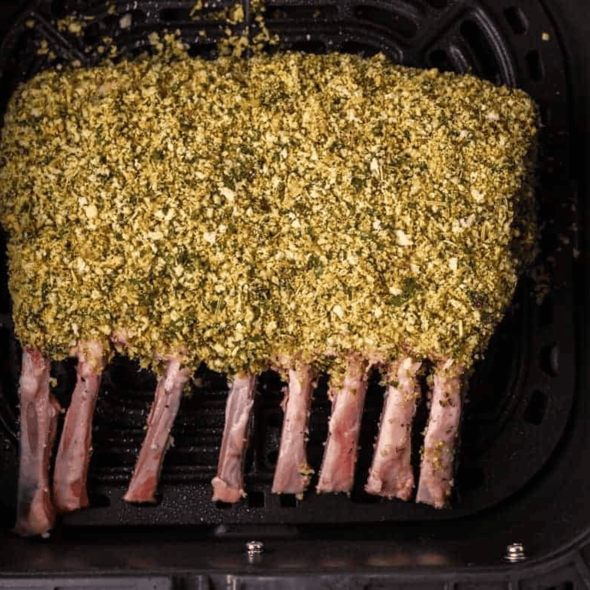 Seasoned rack of lamb in air fryer basket