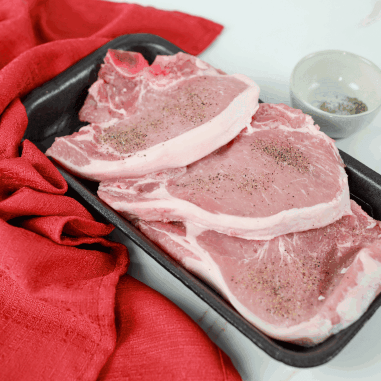 Season your pork chops with salt and black pepper.