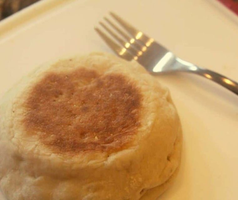 closeup: an english muffin a plate with a fork