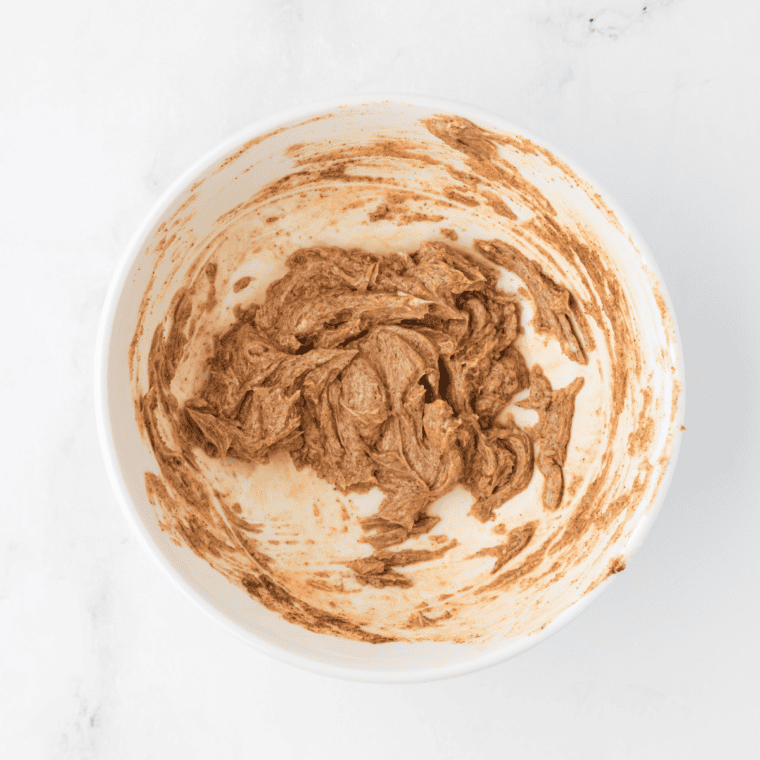 Mixing granulated sugar, ground cinnamon, butter, and vanilla extract in a small bowl.