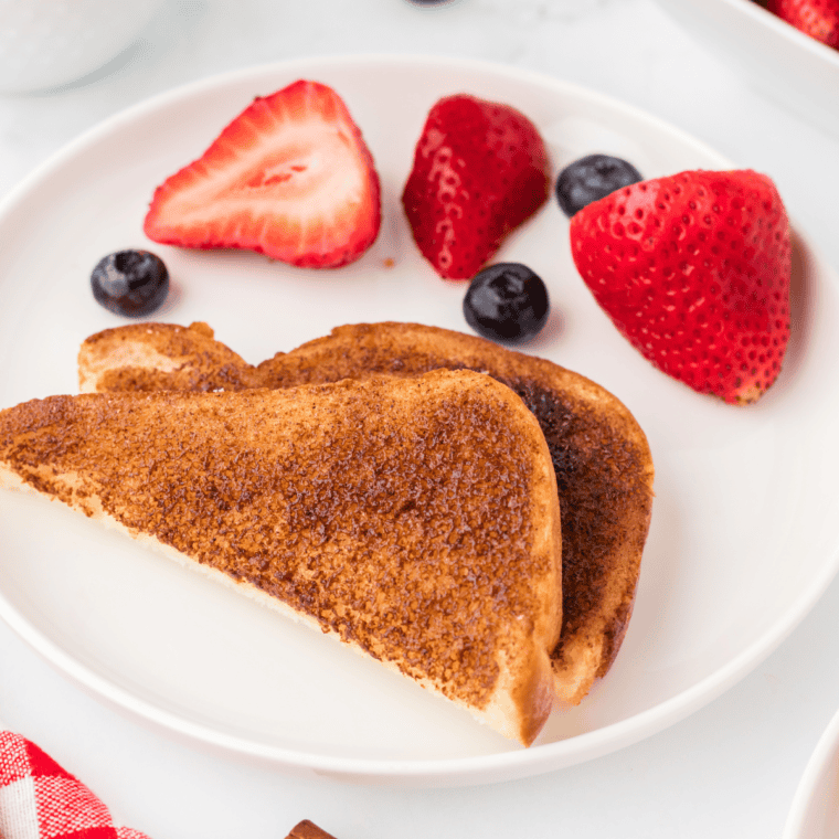 Golden and crispy Air Fryer Cinnamon Toast, freshly made with cinnamon sugar and butter.