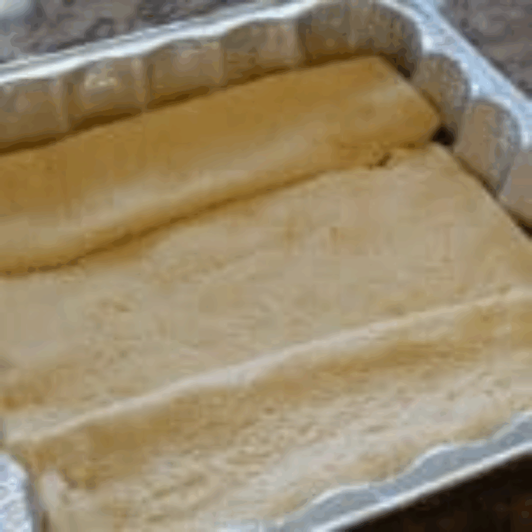 Spreading crescent dough evenly on the bottom of the pan