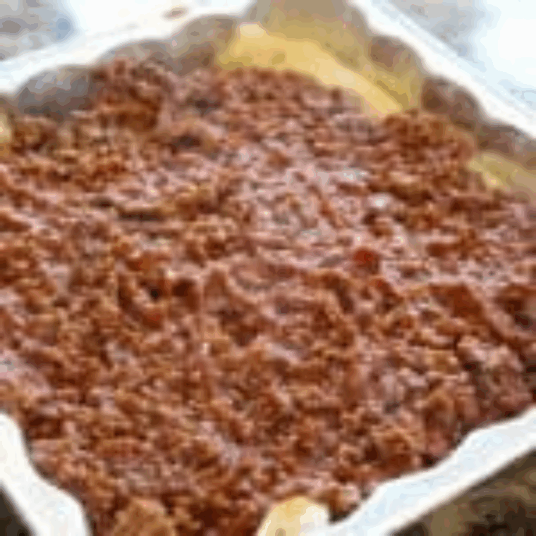 Pouring seasoned sloppy joe beef over crescent dough layer