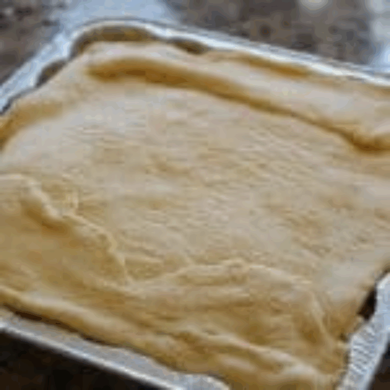 Covering cheesy beef layer with second package of crescent dough