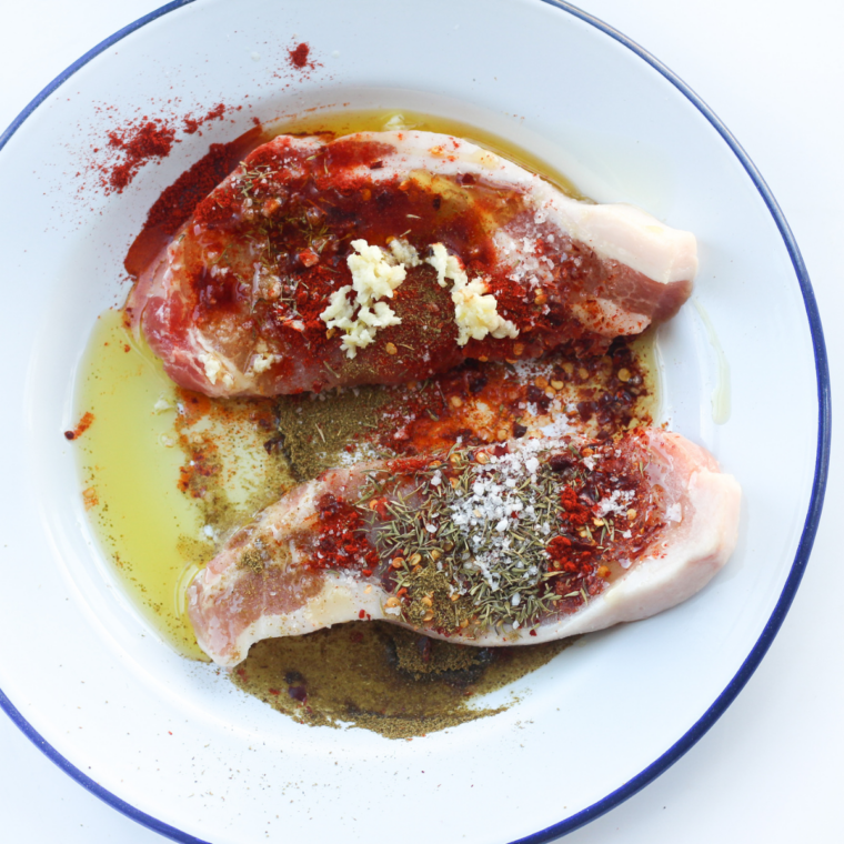 Pork steaks brushed with olive oil and seasoned with spices