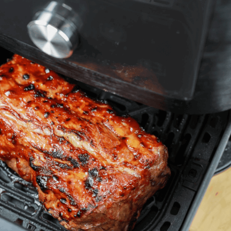 Cooked ribs in the air fryer basket.