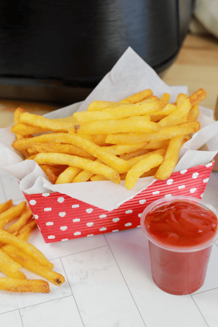 Golden frozen French fries cooked in the Ninja Crispi, served with dipping sauce.