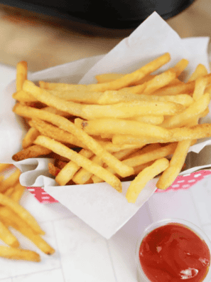 Golden, crispy Ninja Crispi frozen French fries served in a basket, perfect for a quick snack or side dish.