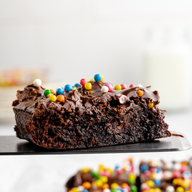 Homemade cosmic brownies with fudgy chocolate layers and colorful candy-coated chocolate chip topping.