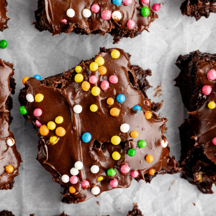 Fudgy homemade cosmic brownies topped with chocolate ganache and colorful candy-coated chocolate chips.