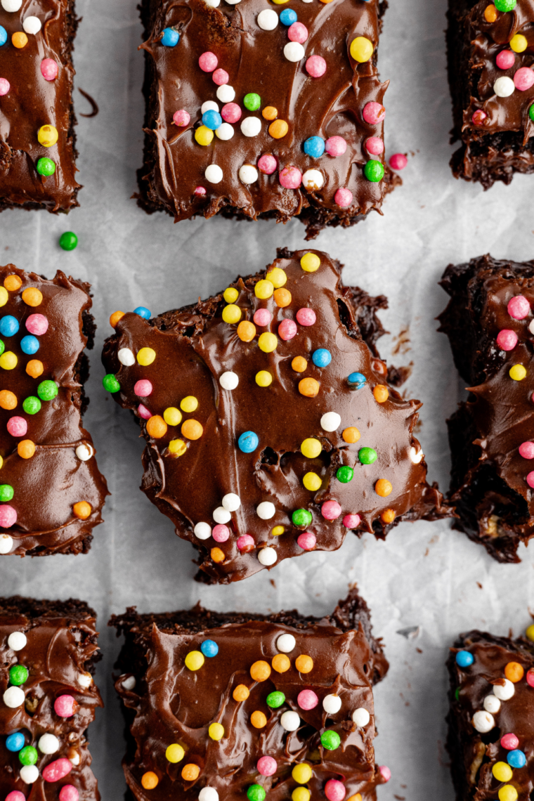 Fudgy homemade cosmic brownies with chocolate ganache and colorful candy-coated chocolate chip topping.