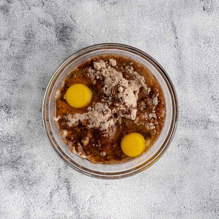 Preparing brownie batter by stirring ingredients from the mix box into a smooth consistency.