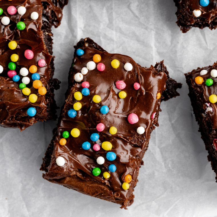 Homemade cosmic brownies with fudgy layers, chocolate ganache, and colorful candy-coated chocolate chip topping.