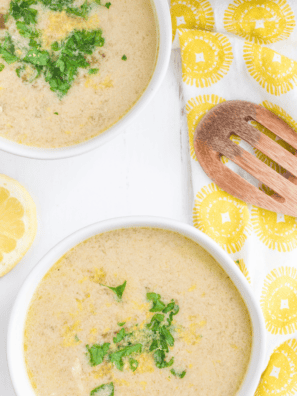 Two bowls of Instant Pot Greek lemon chicken soup (avgolemono) with rice, shredded chicken, fresh dill, and lemon slices