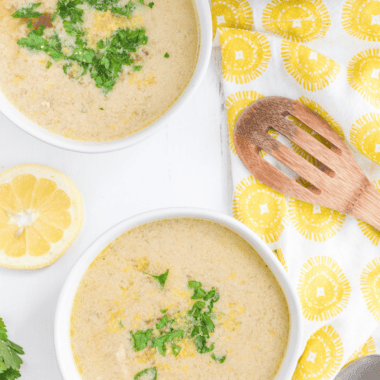 Two bowls of Instant Pot Greek lemon chicken soup (avgolemono) with rice, shredded chicken, fresh dill, and lemon slices