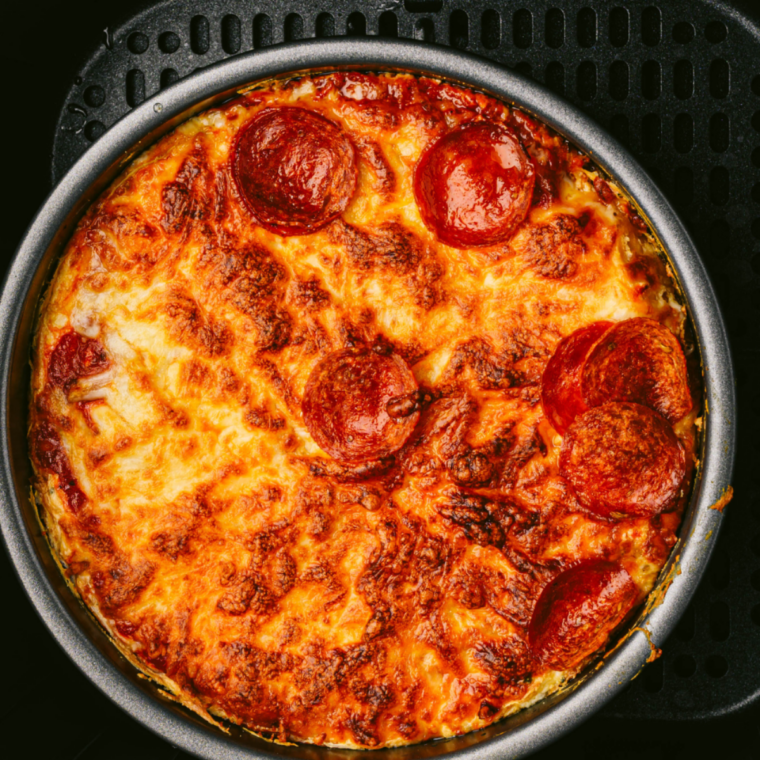 Air fryer bubble-up pizza bake with melted cheese and pepperoni in basket