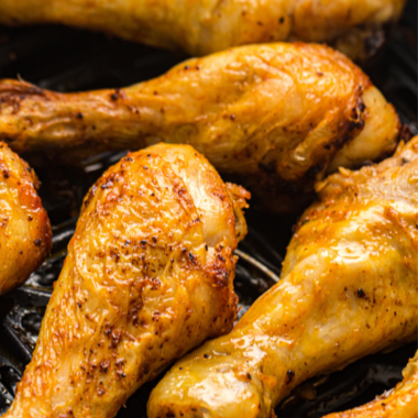 Garlic paprika chicken drumsticks on a white plate
