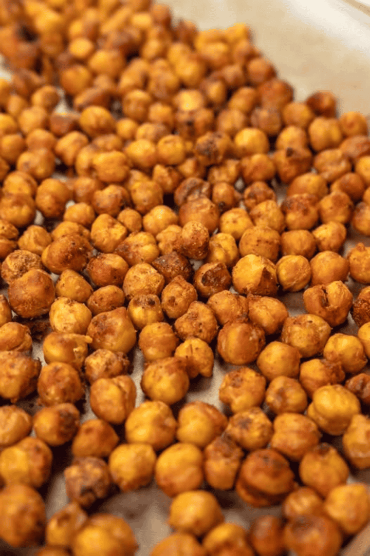 Crispy honey cinnamon roasted chickpeas cooling in a serving bowl.