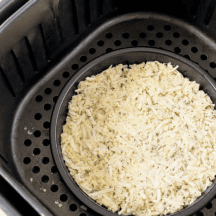 Fry bread cooking in air fryer basket until puffed and golden brown