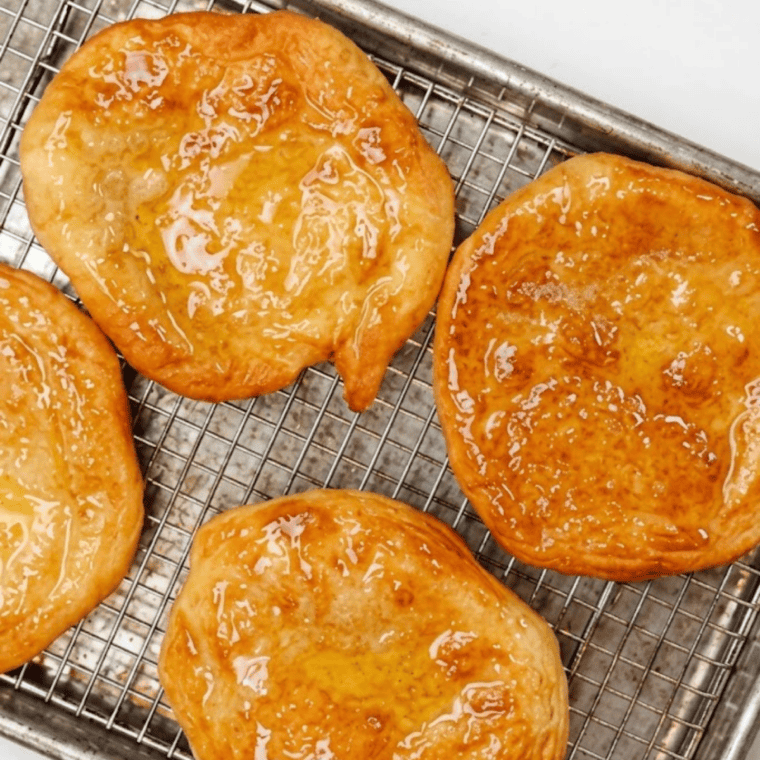 Fry bread in air fryer basket turning golden and crispy