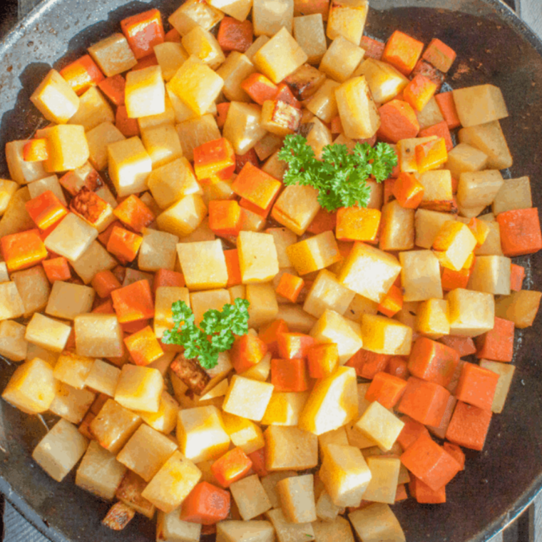 Air Fryer Potatoes and Carrots in a bowl, showcasing the golden-brown, crispy vegetables, garnished with herbs.