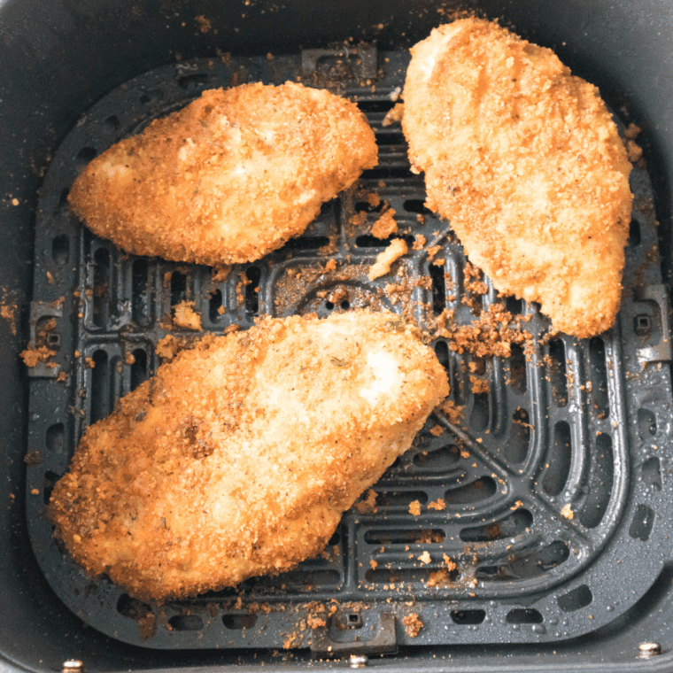 Cooked Carrabba’s Parmesan Crusted Chicken Arugula Recipe in the air fryer basket.