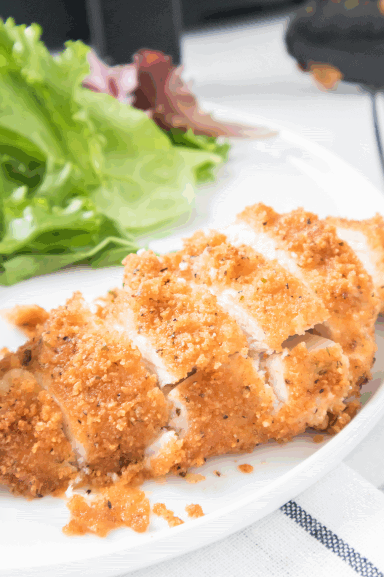 Crispy parmesan crusted chicken breast served on a bed of fresh arugula and cherry tomatoes, drizzled with lemon vinaigrette.