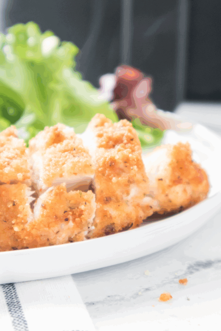 Parmesan crusted chicken breast served on a bed of fresh arugula with cherry tomatoes and lemon vinaigrette.