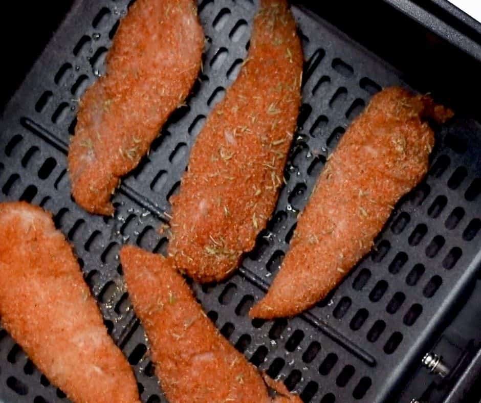 Air Fryer Chicken Tenders in Basket  This is the easiest recipe for naked chicken tenders in an air fryer. She even gives instructions for baking them! Low carb and gluten-free because there is no breading needed. Totally making these for an easy dinner idea. #easydinner #chickenrecipe #airfryer #chickentender #lowcarb #forktospoon
