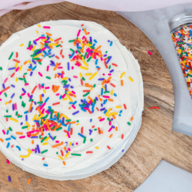 Slice of air fryer birthday cake showing moist, fluffy confetti crumb on a plate