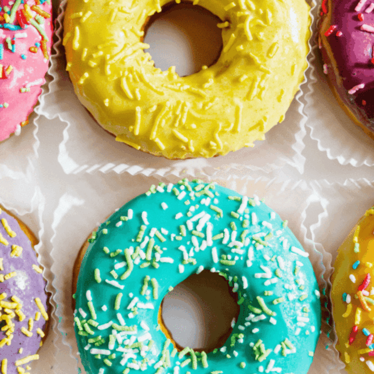Freshly baked Air Fryer Cake Mix Donuts topped with sweet glaze and colorful sprinkles.
